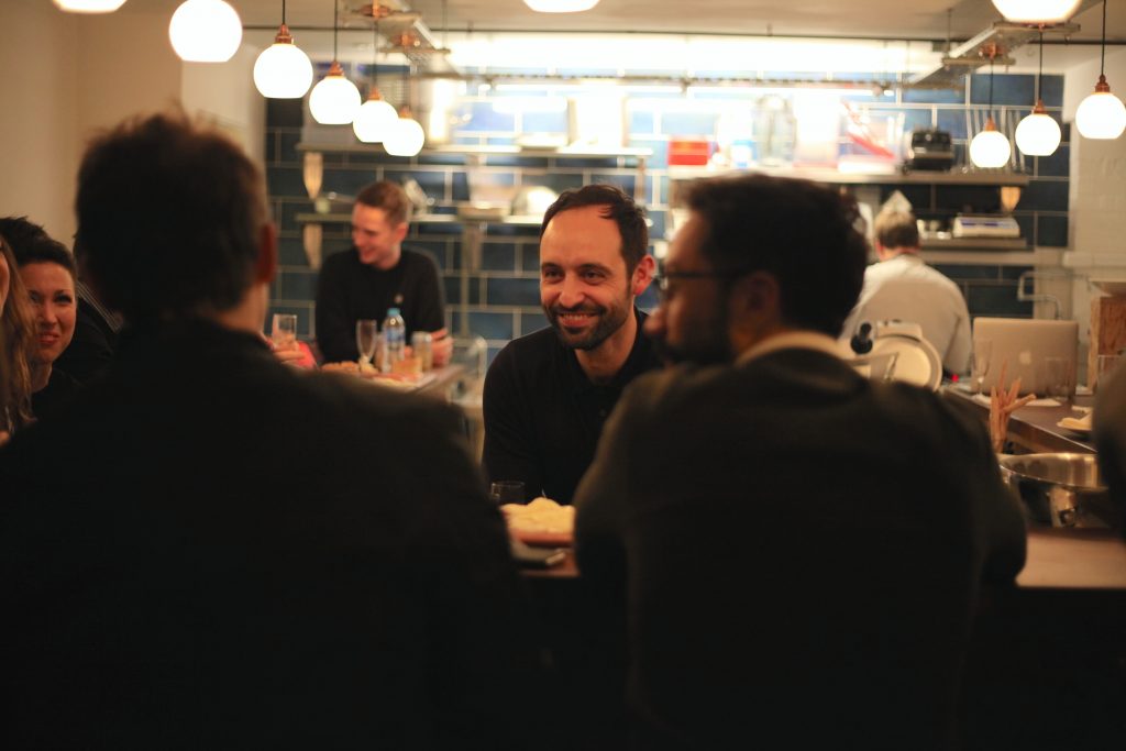 David Toscano, owner of Cin Cin, chatting with guests at the bar