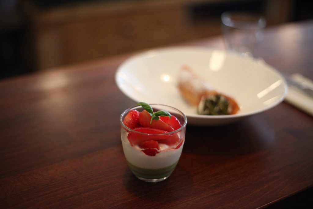 Small bowl of Sussex strawberries, layered with mascarpone and topped with basil