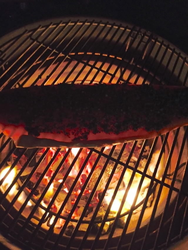 Fish cooking over hot coals